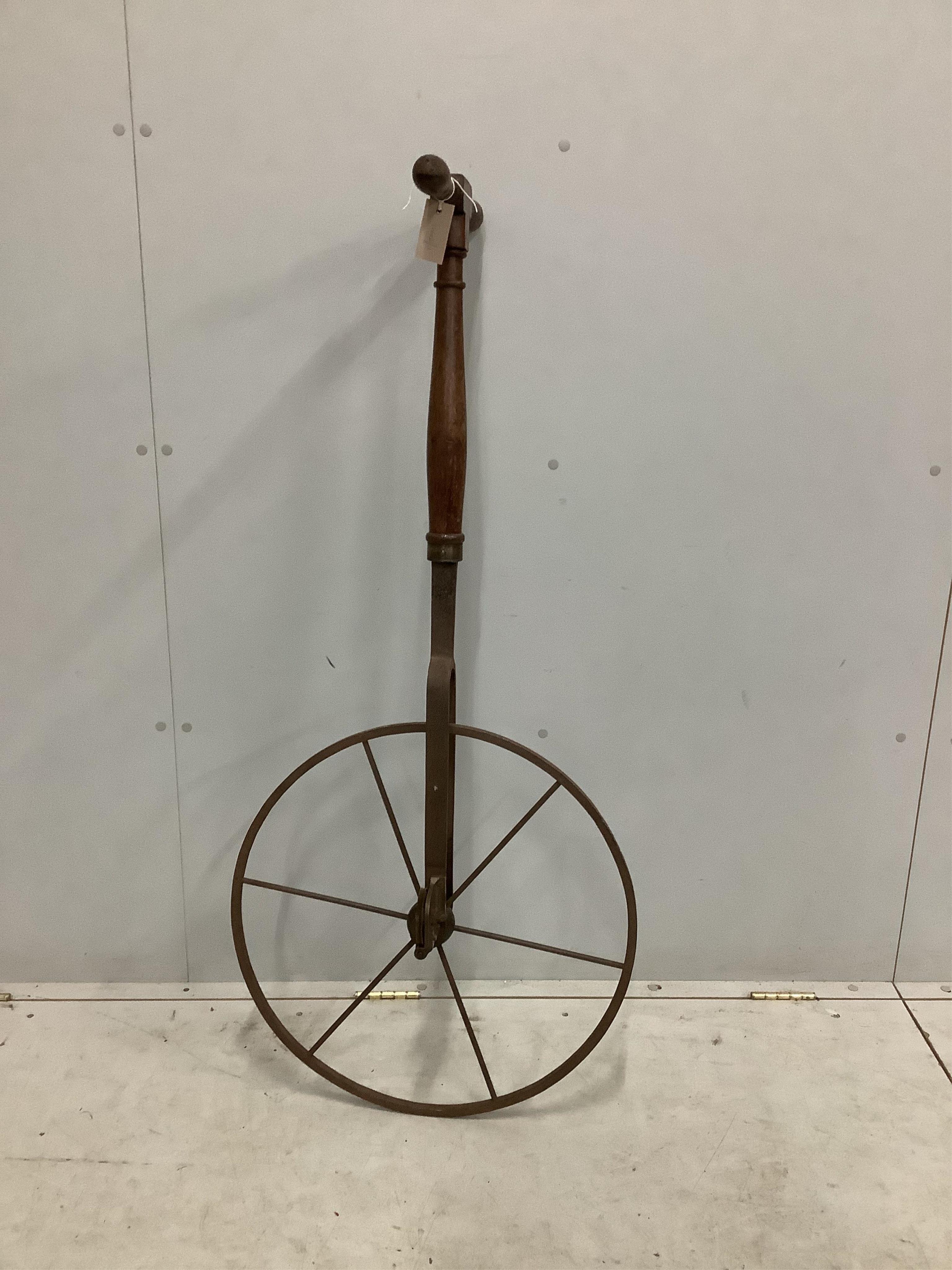 A 19th century Waywiser with six spoke iron wheel and brass dial, height 128cm. Condition - poor to fair